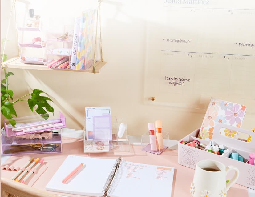 desk with assorted accessories, planner and writing tools.