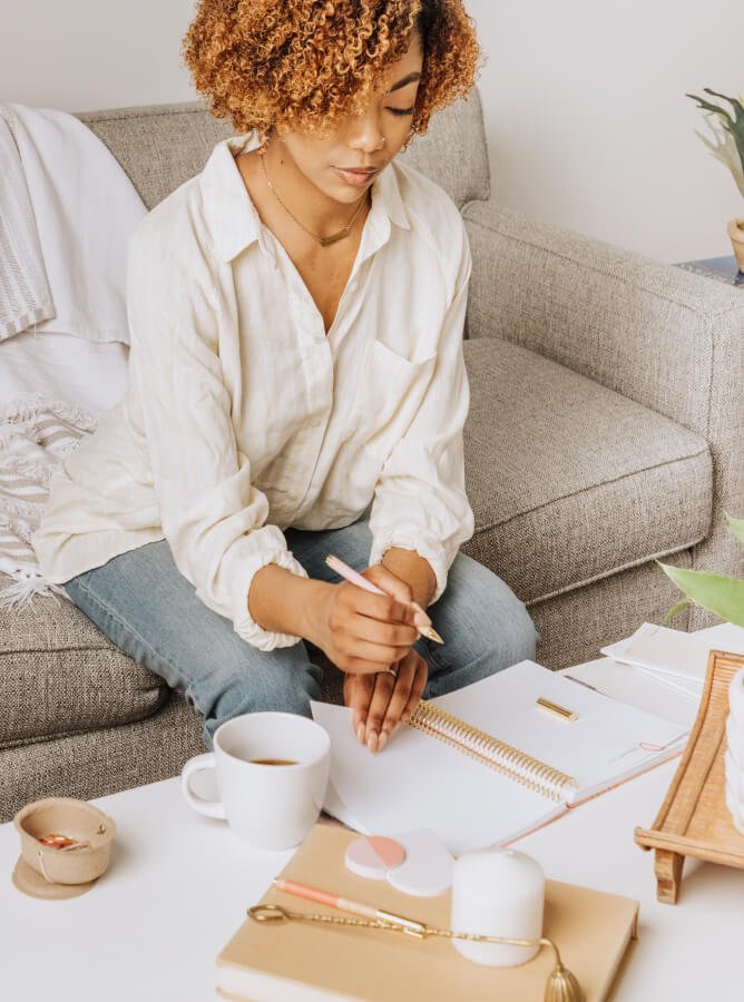 woman writing in coiled planner